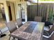 Outdoor patio with table, chairs, and view of the fenced backyard at 908 Boulder Dr, South Daytona, FL 32119
