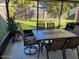Relaxing screened patio featuring a stylish outdoor dining set, ideal for entertaining guests at 908 Boulder Dr, South Daytona, FL 32119