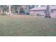 Spacious backyard with mature trees and a comfortable seating area at 921 Valleydale Ave, Deland, FL 32720
