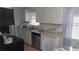 Bright kitchen with white cabinets, modern appliances, and a functional layout for cooking and dining at 921 Valleydale Ave, Deland, FL 32720