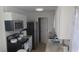 Compact kitchen featuring granite countertops, a microwave, and stainless steel appliances at 921 Valleydale Ave, Deland, FL 32720