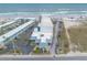 Aerial view of ocean-front building with parking, palm trees, and blue-accented architecture at 935 S Atlantic Ave # 363, Daytona Beach, FL 32118