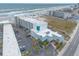 This aerial view shows the beachside building, including nearby parking and ocean access at 935 S Atlantic Ave # 363, Daytona Beach, FL 32118