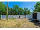 Backyard features a white fence, an outdoor shed, and lush greenery for a serene retreat at 940 Valencia Ave, Daytona Beach, FL 32114