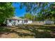 Spacious backyard with lush trees offers privacy and space for outdoor activities and an outdoor shed at 940 Valencia Ave, Daytona Beach, FL 32114
