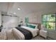 Bedroom features a queen bed, windows, and a sliding barn door at 940 Valencia Ave, Daytona Beach, FL 32114
