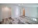 Bedroom featuring wood-look flooring, white walls, closet, and doorway leading to another room at 940 Valencia Ave, Daytona Beach, FL 32114