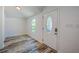 Bright dining area with a white door, a light, grey and white wooden floor and a small window at 940 Valencia Ave, Daytona Beach, FL 32114