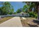 Charming single-story home with light blue exterior, well-manicured lawn, and a long driveway at 940 Valencia Ave, Daytona Beach, FL 32114