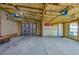 Spacious two-car garage with insulated walls, ceiling, concrete floor, and overhead lighting and doors at 940 Valencia Ave, Daytona Beach, FL 32114