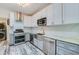 View of the kitchen showcasing stainless steel appliances, sink, microwave, and subway tile backsplash at 940 Valencia Ave, Daytona Beach, FL 32114
