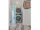 Convenient laundry area with stackable washer/dryer and wood-look flooring at 940 Valencia Ave, Daytona Beach, FL 32114