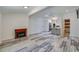 Open living space with stylish flooring, modern fireplace, and seamless flow to kitchen area at 940 Valencia Ave, Daytona Beach, FL 32114