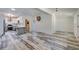 Open-concept living space with modern decor, sleek flooring, and seamless flow to kitchen at 940 Valencia Ave, Daytona Beach, FL 32114