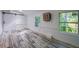 Bright living room with wood-look flooring, white walls and trim, sliding barn door, and large windows at 940 Valencia Ave, Daytona Beach, FL 32114