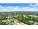 Aerial view of a residential neighborhood featuring lush greenery and a tranquil lake at 941 Pizarro Dr, Daytona Beach, FL 32119