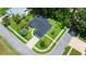 Overhead view of a gray home showcasing its manicured yard, driveway, and proximity to a quiet street at 941 Pizarro Dr, Daytona Beach, FL 32119