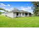 Expansive backyard with lush green lawn and partial view of the home at 941 Pizarro Dr, Daytona Beach, FL 32119