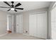 Bedroom featuring a ceiling fan, closet, and neutral walls and carpet at 941 Pizarro Dr, Daytona Beach, FL 32119