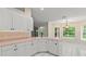 Bright kitchen features white cabinetry and breakfast nook with natural light at 941 Pizarro Dr, Daytona Beach, FL 32119