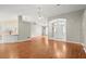 Bright living space with wood-look flooring, modern light fixtures, and open flow into the kitchen area at 941 Pizarro Dr, Daytona Beach, FL 32119