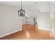 Expansive living area with wood-look floors, contemporary lighting, and seamless flow to other rooms at 941 Pizarro Dr, Daytona Beach, FL 32119