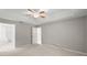 Spacious main bedroom offers neutral color, ceiling fan, and en-suite bathroom at 941 Pizarro Dr, Daytona Beach, FL 32119