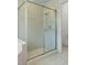 Glass enclosed shower with tile surround, a showerhead and temperature controls at 941 Pizarro Dr, Daytona Beach, FL 32119