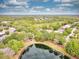 Scenic aerial view capturing the tranquil lake and the surrounding lush landscape and neighborhood at 1018 Heron Point Cir, Deland, FL 32724