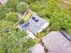 Aerial view of a house with solar panels, a well manicured yard, and mature trees at 1018 Heron Point Cir, Deland, FL 32724