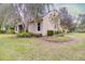 Backyard featuring mature landscaping, mulch beds, and lush green grass at 1018 Heron Point Cir, Deland, FL 32724