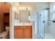 Bright bathroom featuring dual vanity sinks, walk-in glass shower, with natural light at 1018 Heron Point Cir, Deland, FL 32724