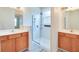 Bathroom featuring dual vanity sinks, walk-in glass shower, with natural light from the window at 1018 Heron Point Cir, Deland, FL 32724