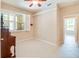 Bright bedroom featuring a ceiling fan, tiled floor, and shuttered window at 1018 Heron Point Cir, Deland, FL 32724