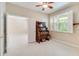 Bedroom with a ceiling fan, shutters on the window and open door to the next room at 1018 Heron Point Cir, Deland, FL 32724