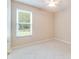 Bright bedroom with ceiling fan, tile flooring, and window for natural light and neighborhood views at 1018 Heron Point Cir, Deland, FL 32724