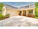 Wide driveway leading to a two-car garage and a charming front porch with decorative stone accents at 1018 Heron Point Cir, Deland, FL 32724