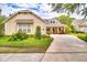 Charming single-story home with a well-manicured lawn, a welcoming porch, and a private driveway at 1018 Heron Point Cir, Deland, FL 32724