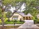 Charming home featuring a well-manicured lawn, inviting front porch, and a convenient circular driveway at 1018 Heron Point Cir, Deland, FL 32724