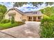 Beautifully designed home with solar panels, a manicured lawn, and a spacious driveway leading to the garage at 1018 Heron Point Cir, Deland, FL 32724