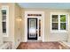 Elegant glass-paneled front door with sidelights and decorative brick pillars, enhancing the home's curb appeal at 1018 Heron Point Cir, Deland, FL 32724