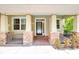 Inviting front porch with stone accents, a decorative railing, and a stylish glass-paneled front door at 1018 Heron Point Cir, Deland, FL 32724