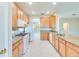 Spacious kitchen boasts stainless appliances, granite counters, and wood cabinets at 1018 Heron Point Cir, Deland, FL 32724