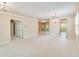 Expansive living room boasts tile floors, neutral paint, and elegant chandelier lighting at 1018 Heron Point Cir, Deland, FL 32724