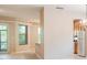 Open-concept living space with neutral walls, a view of the kitchen and natural light from the balcony access at 1018 Heron Point Cir, Deland, FL 32724