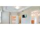 Bright main bedroom boasts tray ceiling, TV, and open doorway to kitchen and bathroom at 1018 Heron Point Cir, Deland, FL 32724