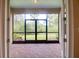 Screened patio with brick floor overlooks backyard landscaping at 1018 Heron Point Cir, Deland, FL 32724