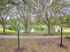 Scenic view of a pond lined with trees and lush greenery, creating a peaceful neighborhood atmosphere at 1018 Heron Point Cir, Deland, FL 32724