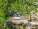 Overhead view of the property showcasing the roof, yard, and driveway with mature trees at 102 Judges Ln, Port Orange, FL 32129