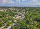 Panoramic aerial view of the neighborhood with the bay and city skyline in the distance at 102 Judges Ln, Port Orange, FL 32129